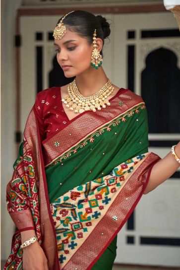 Patola Printed Lovely Art Silk Fabric Saree In Dark Green Color