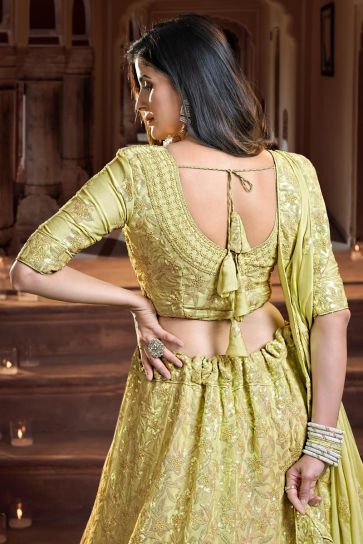 Georgette And Net Fascinate Sequins Work Reception Wear Lehenga Choli In Yellow Color