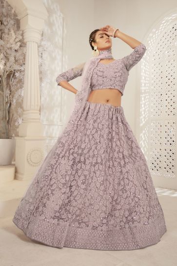 Tempting Net Fabric Chikoo Color Function Wear Lehenga With Embroidered Work