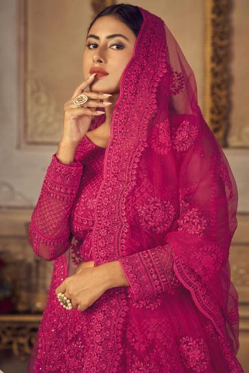 Sangeet Wear Glamorous Embroidered Net Lehenga Choli In Rani Color
