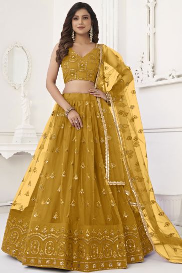 Sequins Embroidered Mustard Color Net Fabric Trendy Lehenga For Sangeet Function