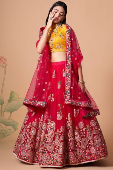 Dazzling Sangeet Wear Rani Color Lehenga Choli In Net Fabric