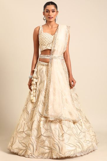 Net Fabric Wedding Wear Lehenga Choli In Cream With Sequins Work