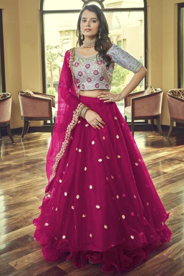 Tempting Net Fabric Rani Color Lehenga With Embroidered Work