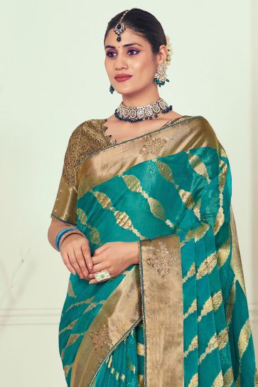 Organza Fabric Teal Color Intriguing Weaving And Stone Work Saree